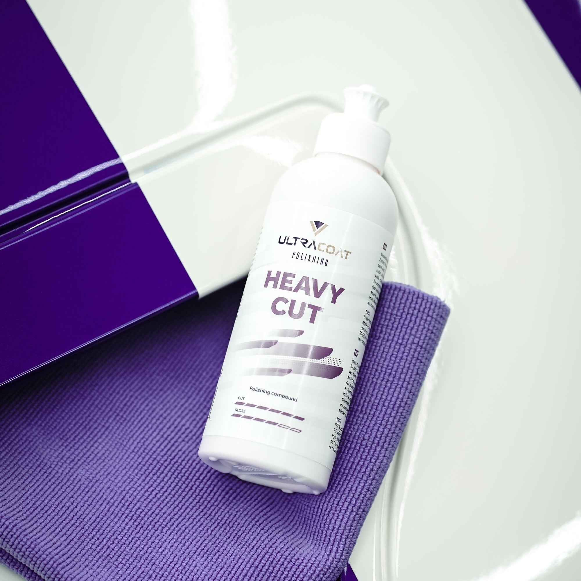 ULTRACOAT Heavy Cut polishing compound with a purple microfiber cloth