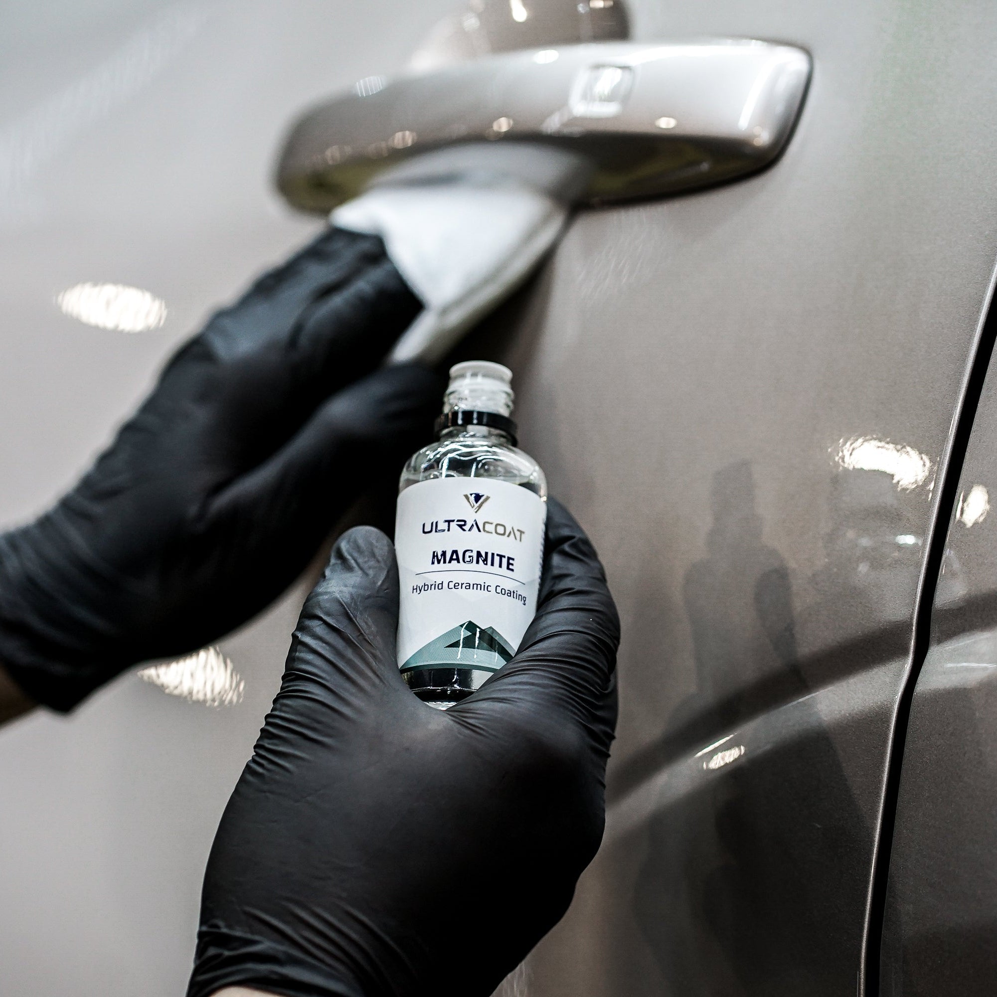 ULTRACOAT Magnite bottle with an applicator on automotive paint
